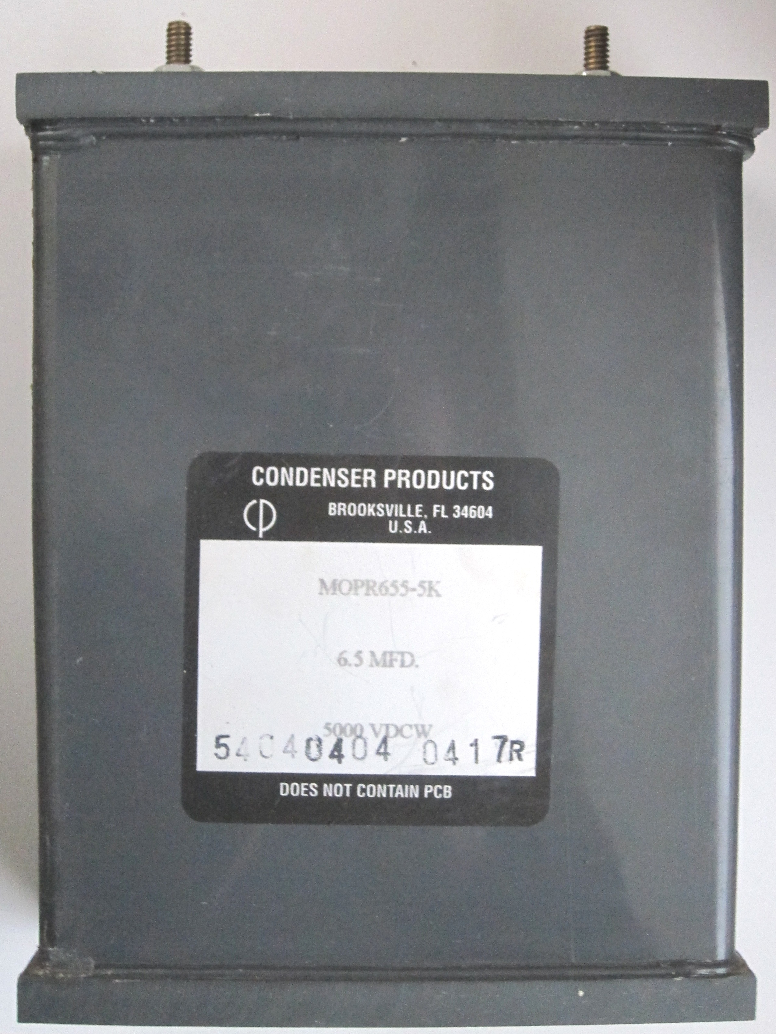 Figure 6 — A large oil-filled capacitor in a sealed metal can. Big oil-filled paper capacitors — and the potted capacitors inside old fluorescent-light ballasts and motor-run applications — are the…