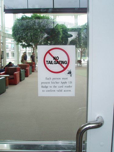 Figure 4 — A "no tailgating" sign at Apple's corporate office — a representative awareness-control deployment. The sign-based defense layer is the cheapest physical-entry deterrent: it costs essentially nothi…