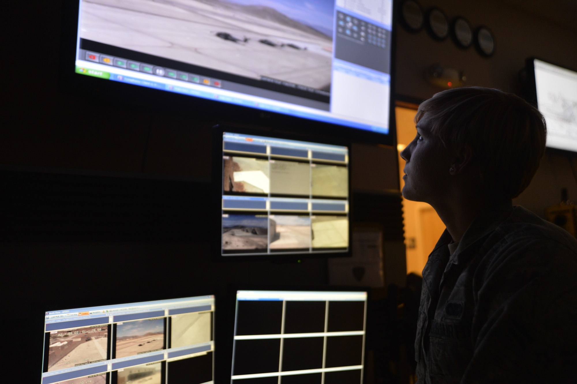 Figure 5 — A monitoring station in operation: an alarm monitor at a base defense operations center watching camera and alarm status for abnormal activity. This is the human end of the IDS — the UL …
