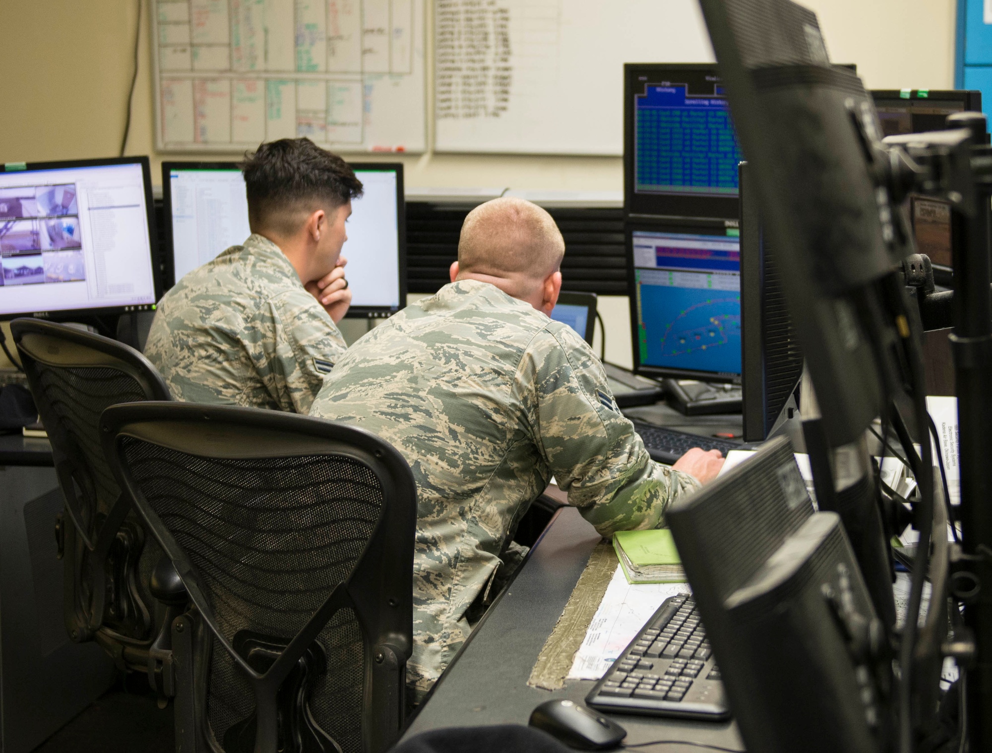 Figure 6 — The dispatch side of the same function: security-forces alarm monitors at a centralized base defense operations center. The station receives supervised alarm and access signals from many…