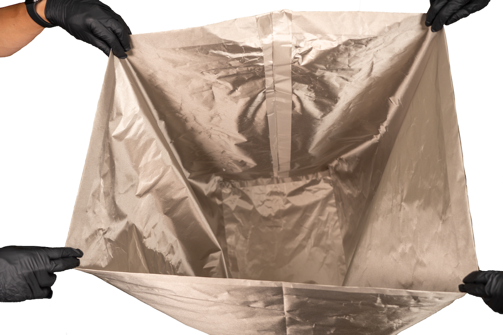 Figure 4 — Metallized shielding fabric up close. Nickel/copper-plated ripstop and taffeta textiles are the amateur Faraday-room's workhorse: flexible, staplable, and specified in the 60–80 dB range…