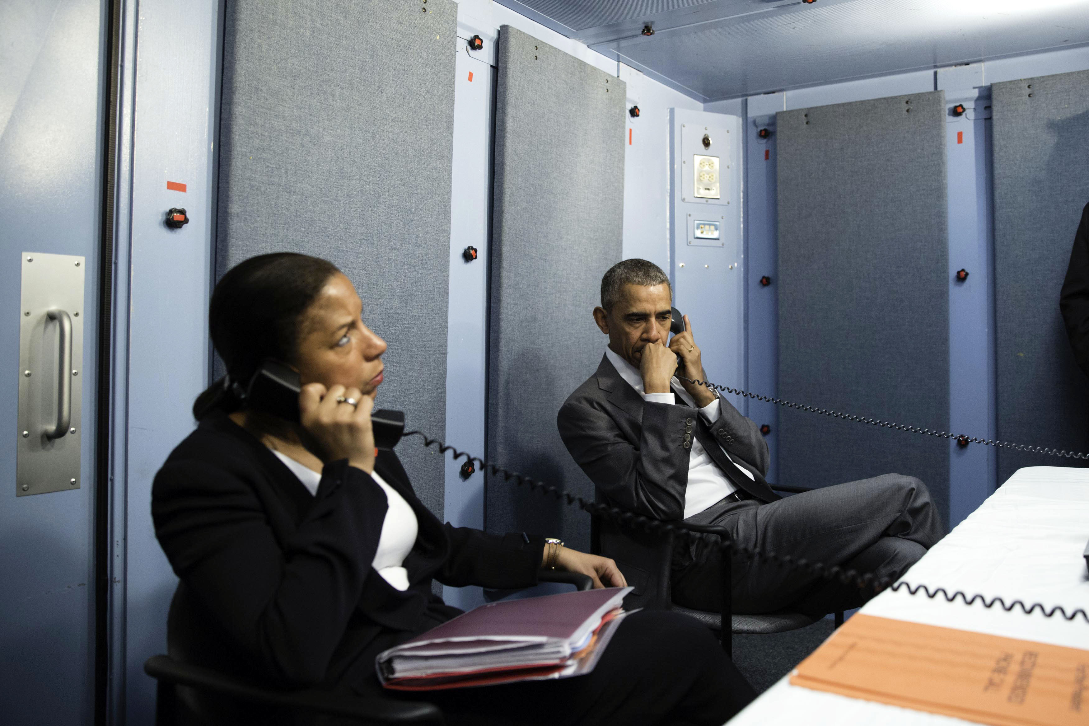 Figure 7 — A modern deployable secure facility in use: President Obama in a portable SCIF, 2016. The lineage runs unbroken from FDR's map room and the embassy screen room to accredited, sometimes t…