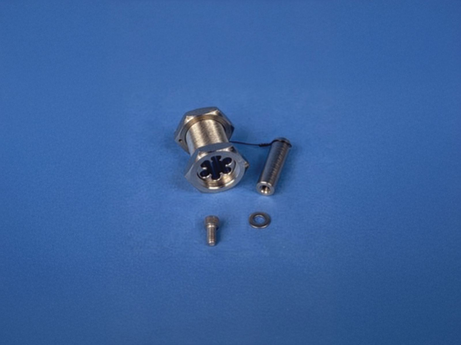 Figure 6 — Figure F — A waveguide feed-through for fiber-optic penetration of a shielded enclosure: an array of below-cutoff bores that pass dielectric fibers through the shield while attenuating any field th…